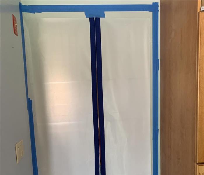 poly plastic barrier blocking entrance, blue tape
